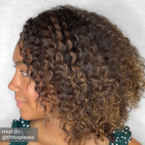 African American female with short curly lightened textured hair