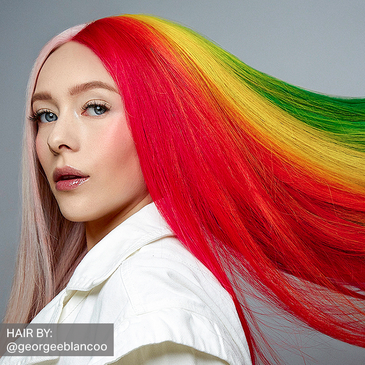 A caucasian female model with long straight rainbow color hair