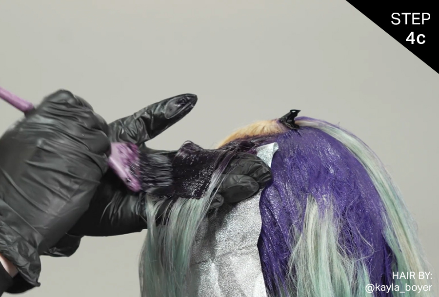 VIVIDS Formula 1 (Black Violet) is applied to the bottom half of the mohawk section of the female model's hair