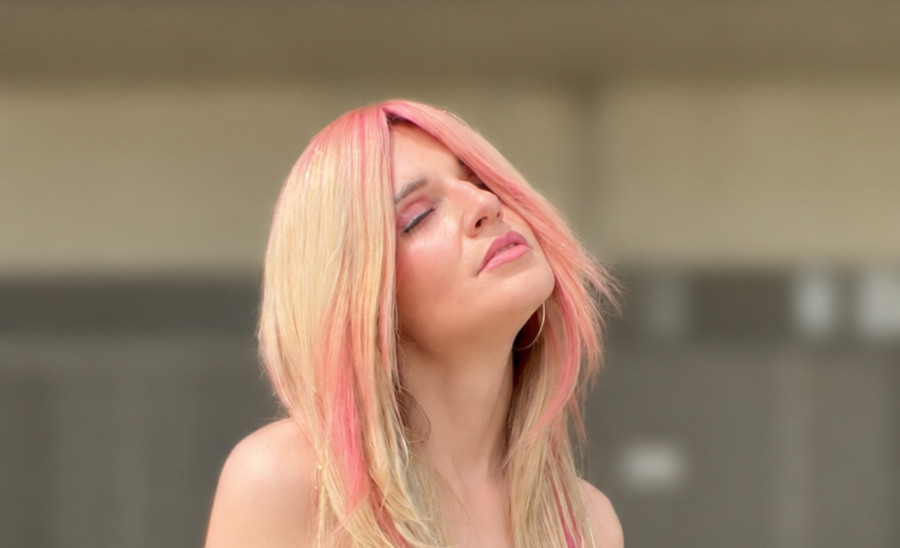 Dimensional Miami Vice-inspired frozen cocktail hair color blending icy blonde and vibrant, pastel pink waves.