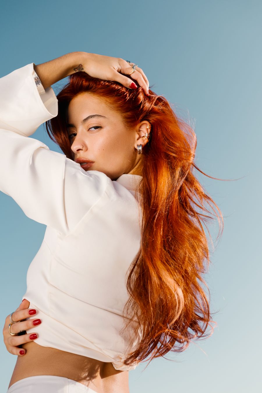 PRAVANA ChromaSilk 7C copper hair color with long wavy copper hair, glossy shine, and care-free summer texture.