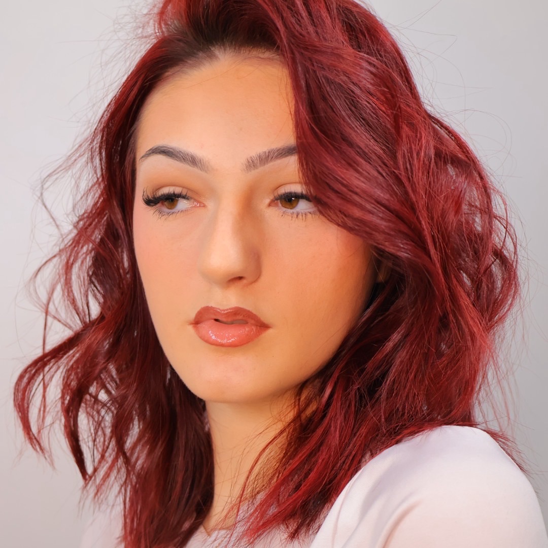 Bright red hair color kicked up with magenta using PRAVANA ChromaSilk VIVIDS Everlasting, creating an electric pinky-red fashion shade.